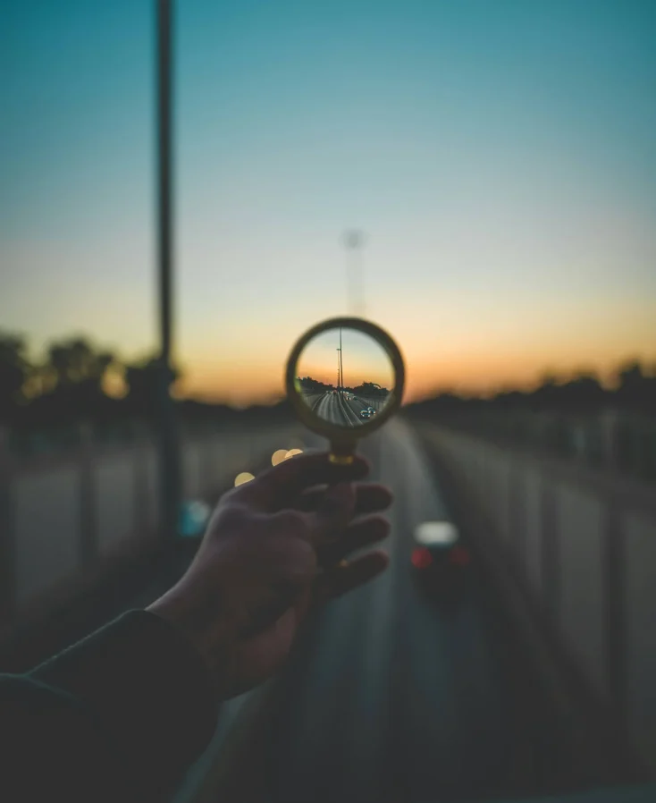 SEO A magnifying glass held up to a street.